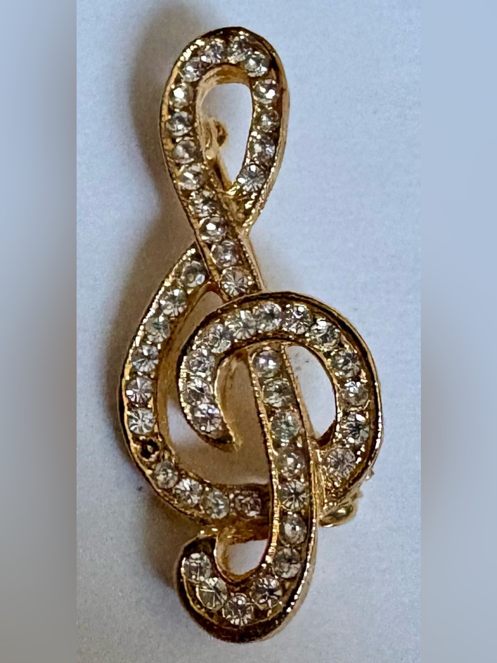 Gold-tone metal treble clef brooch & clear rhinestones vintage costume jewelry